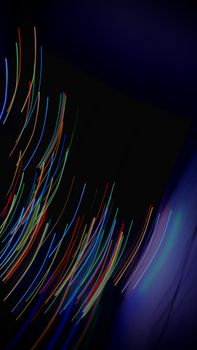 Dynamic long exposure capture of colorful light trails creating an abstract pattern.