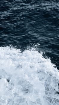 Dynamic capture of ocean waves crashing with splashing water on a vibrant sea surface.
