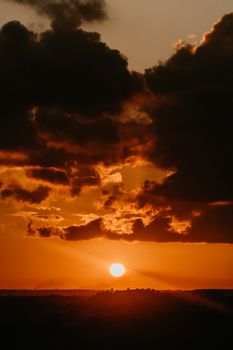 A breathtaking view of a dramatic sunset with golden clouds on the horizon.