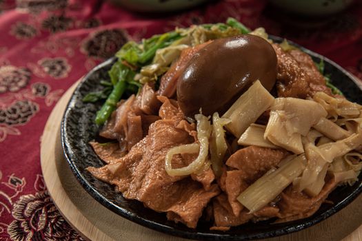A savory dish featuring traditional Taiwanese street food with a marinated egg and vegetables, perfect for food enthusia