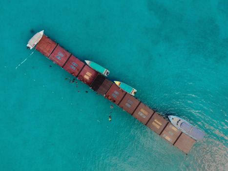 Aerial shot of a pier with boats in clear turquoise water, Kuala Terengganu, Malaysia.