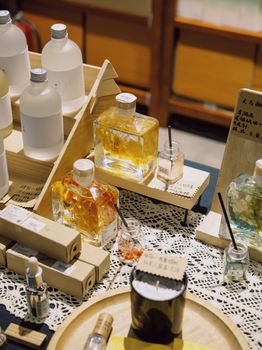 A stylish composition featuring assorted perfume bottles and accessories on a lace-covered table.