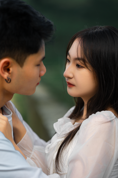 A young Asian couple embracing outdoors in Dalat, Vietnam, expressing love and connection.