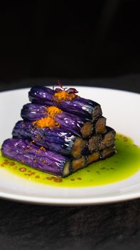 Tantalizing eggplant dish elegantly plated with colorful sauces, perfect for gourmet food lovers.