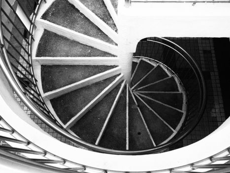 Artistic monochrome image of a spiral staircase in Hong Kong.
