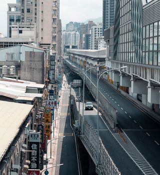 A city street view in New Taipei City, Taiwan with urban buildings and road signs.