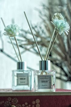 Stylish indoor reed diffuser with white flowers and aromatic scent, perfect for home decor.