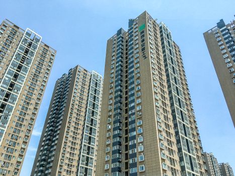 Modern skyscrapers standing tall in an urban cityscape under clear blue skies.