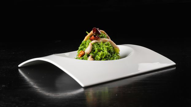 Close-up of a gourmet vegetable dish elegantly presented on a designer plate, perfect for fine dining settings.